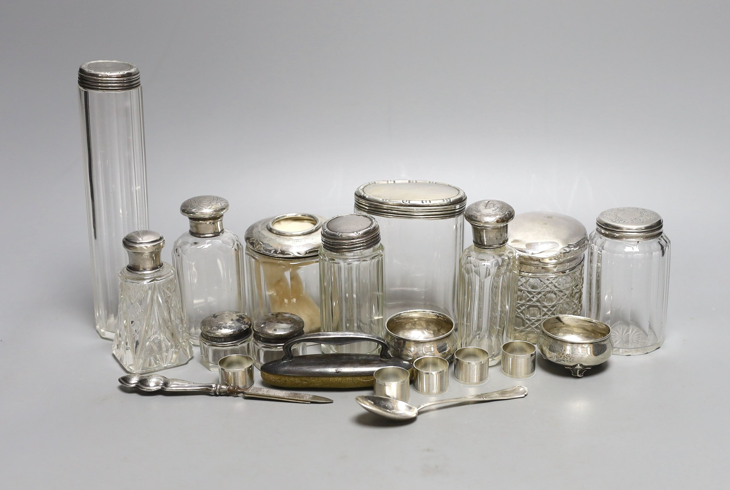 Eleven assorted silver topped glass toilet jars, a pair of 800 salts and eight other items.
